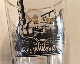 Detail of pair of Libbey Collins glasses with steam locomotives and gold trim