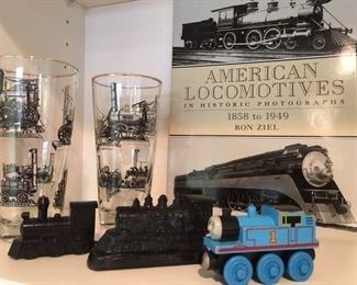 Pair of Collins glasses with steam locomotives in black and gold trim by Libbey, also assorted small vintage toy trains, and books on trains (see next photo)