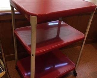 Vintage red painted metal, tiered rolling cart with chrome supports; some styles of the day had an electric plug attached but this model does not