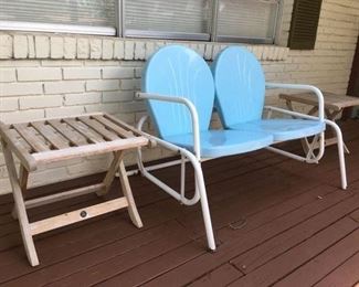 Retro repro two-seat metal glider in blue and white paint, also a pair of teak end tables