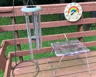 wind chimes, outdoor thermometer, wrought iron table
