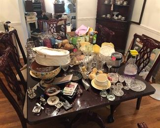 pardon the mess...they were still busy staging the sale when I took photos. This is a high end table and chairs-dark cherry/mahogany tones.