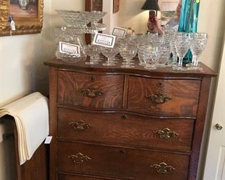 Antique oak highboy chest loaded with Fostoria American pattern glassware
