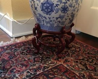 Decorative blue and white planter on Karastan rug