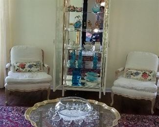 Cream Arm Chairs w/ Down cushions. Brass/Glass coffee table, Mirrored Display cabinet, Karastan Rug 
