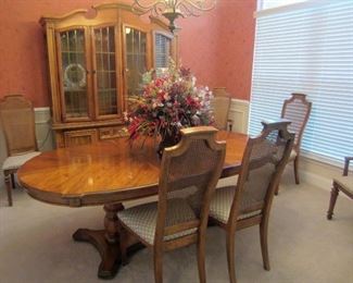Fruitwood dual pedestal dining table with two leaves and six chairs (two arm) and matching china cabinet