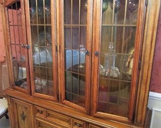The fruitwood lighted china cabinet