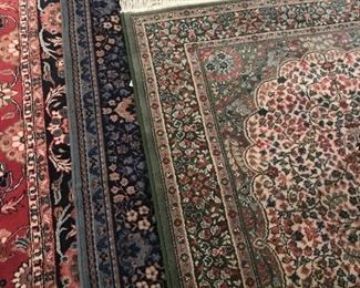 Many wool rugs of various colors, and sizes