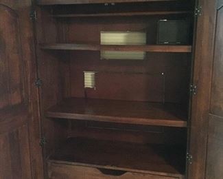 Has shelves, drawers, and/or bar for clothing. Also has a built in safe!