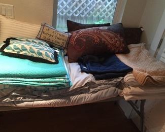 Lots of beautiful bed coverings