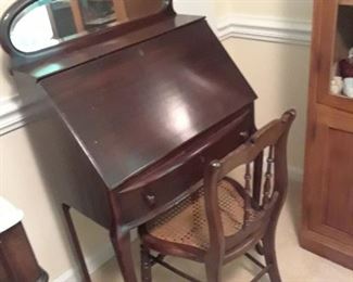 Mahogany desk with elongated mirror at top and single drawer. Circa 1900.