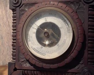 Old barometer in carved wood case