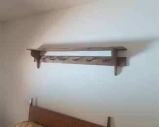 Wooden shelf with pegs