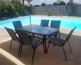 Brand new patio set.  Dark brown metal frame. Table is glass-top and chairs are mesh