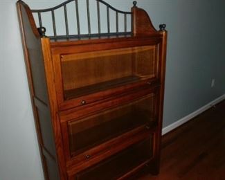 Triple barrister bookcase with iron back valance.