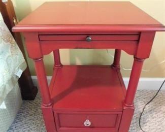 Red nightstand with storage shelf and drawer