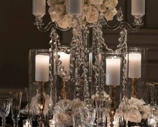 Candelabras in crystal, gold and silver with coordinating candlesticks and hurricanes. Over 75 varieties and styles of votives. Crates of Swarovski crystal ropes and pendants. 