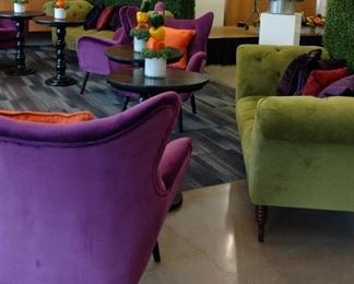Colorful, plush velvet furniture; black pedestal tables; boxwood hedges; acrylic pedestals and vessels. Oversized square, rectangle and circular area rugs in a variety of colors. 