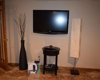 Flat Screen TV, Floor Lamp, Accent Table, Vase W/Floral Accents