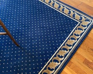 Blue area rug measuring 5 1/2' x 7 1/2'.  There is also one measuring 4' x 5' and 3 runners.