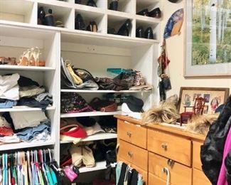Large closet filled with designer clothing and shoes