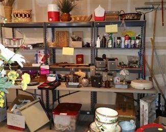 Three steel shelving units: $35.00 each. Nice wall decor, Rubbermaid, tupperware, pyrex, small appliances, Christmas tree, fertilizer spreader, small hand tools, yard tools, baskets and more