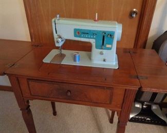 singer sewing machine in cabinet