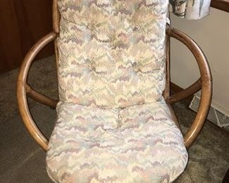One of two matching rattan chairs.
