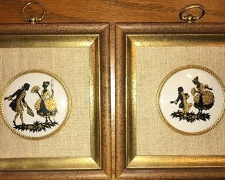Framed pair porcelain medallions showing colonial scenes.