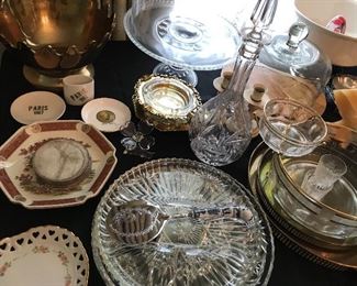 Tables full of decor, glassware, silver plated items, candle holders and more.