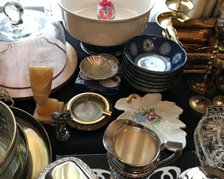 Tables full of decor, glassware, silver plated items, candle holders and more.