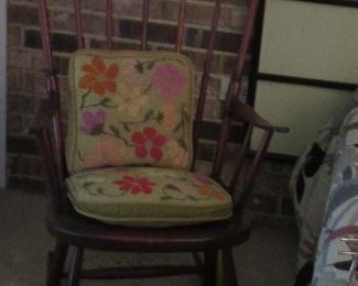 Close-up of the antique rocking chair with cushions.