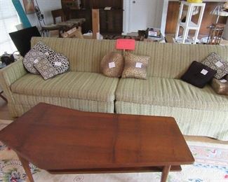 Two-piece sofa.  Lots of decorative throw pillows throughout home.  Vintage, mid-century walnut "boomerang" table w/ lower shelf.