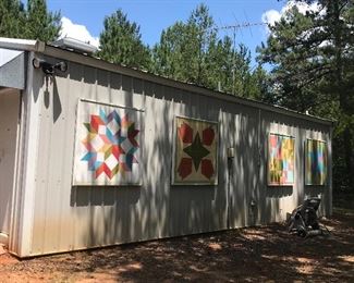 Large outer building/Apartment, on slab included in property. Painted panels are cool idea for decor . But will not be available for purchase during the sale.