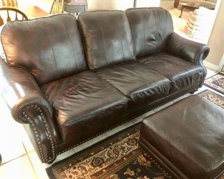 Spectacular studded brown leather sofa and ottoman.  