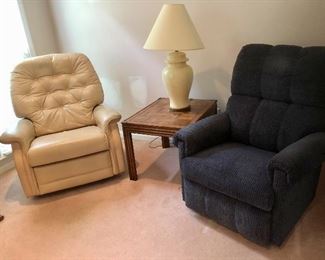 Pair of Lay-Z-Boy recliners.  One in cream leather has some wear. 