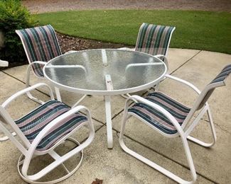 White patio glass-topped table and chairs  