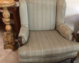 Upholstered chairs.  One shown here is a lovely green upholstery with wood accents but there are many more.  Also shown a beautiful carved wood pedestal.  