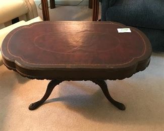 Antique leather-topped coffee table. 