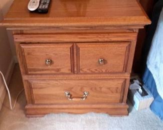 Two oak end tables with pullout shelf.