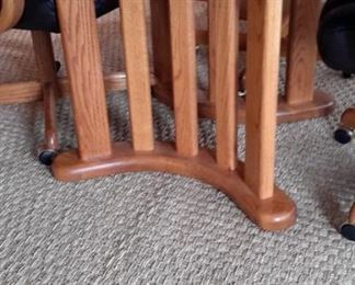 Very nice oak table with four real leather swivel chairs on casters. One leaf.