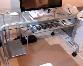 Like new metal and glass computer desk with casters (2).