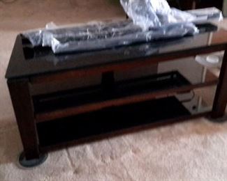 Glass top TV stand with TV brackets included.