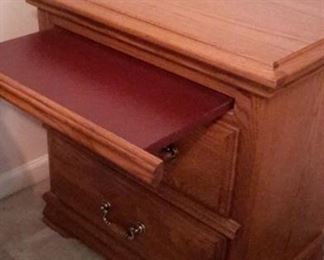 Two oak end tables with pullout shelf.