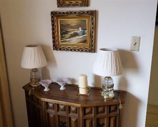 Vintage side cabinet. Crystal lamps, oil paintings
