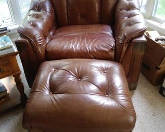 Brown leather overstuffed chair with matching ottoman