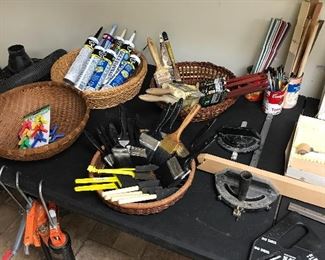 New paintbrushes, tubes of caulk, caulk guns and accessories
