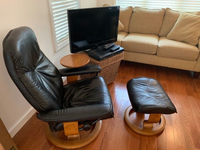Vintage Ekornes recliner chair with swivel table and matching ottoman.
Teak wood frame. 
Leather has vintage wear. Unmarked, no label present from the maker. 
