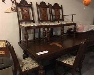 Large dining room table, 5 chairs, has visible damage to top, but could easily be painted to look however you want (one of chairs is a captains)
