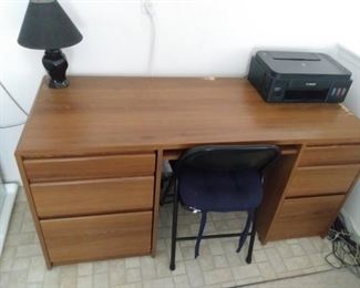Wooden desk with a lamp and printer